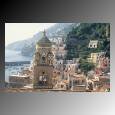 Bell tower standing above densely populated houses in the town of Amalfi along the Amalfi Coast